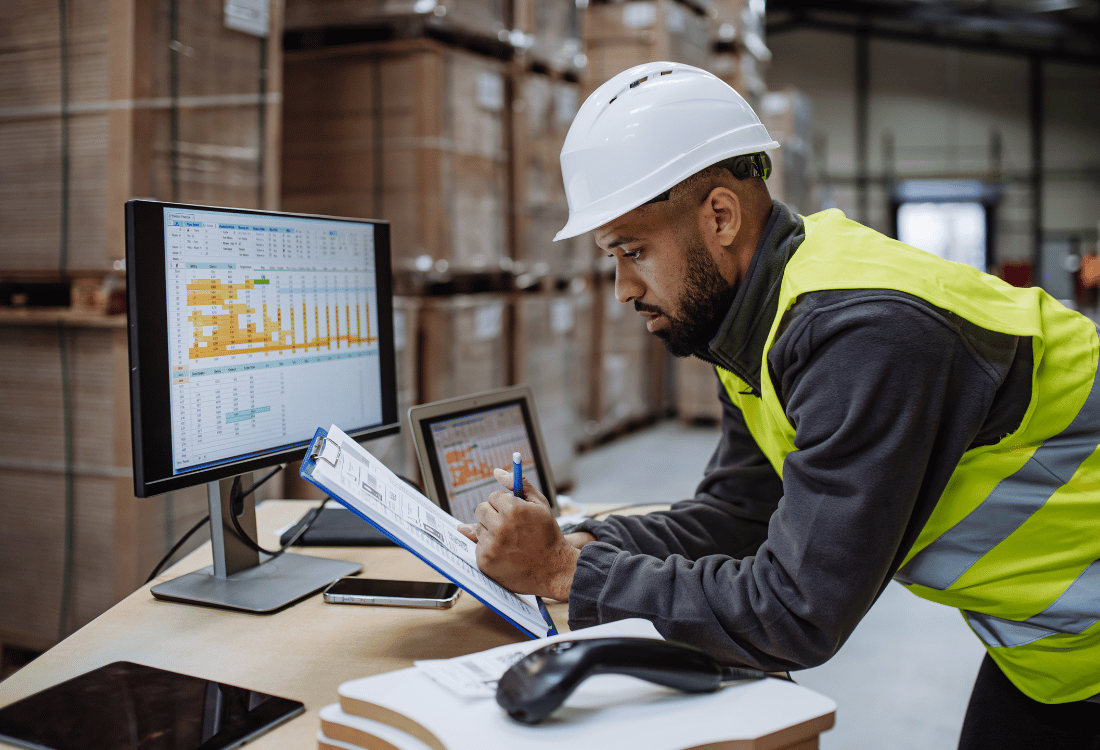 Facilities manager using a mailroom tracking system to organise parcels in a warehouse.