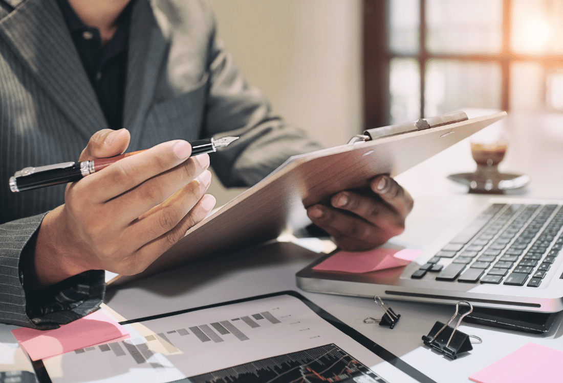 An employee integrating a paper file management system and ticking off the next steps.